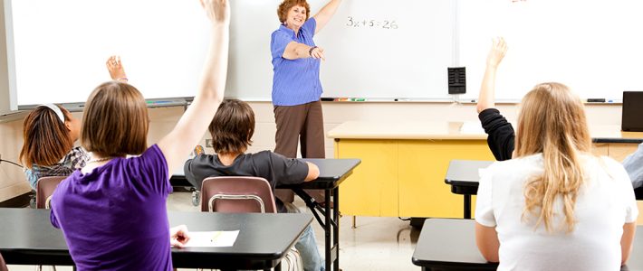 High school math teacher calls on students to solve a problem.